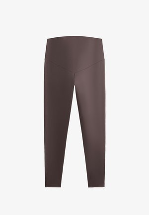 Leggings marroni a vita alta con una superficie liscia, gambe affusolate e un design della vita a forma di V. Nessun motivo o accento visibile.