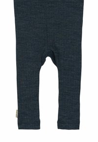 Donkergrijze leggings van zacht, rekbaar materiaal. Heeft een geribbelde tailleband en een ronde uitsnede in het midden.