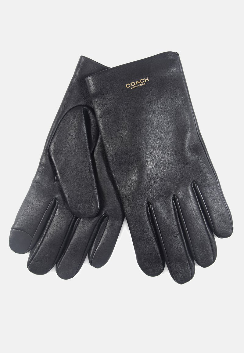 Gants en cuir noir avec une texture lisse, un design ajusté, cinq doigts et le logo doré "COACH NEW YORK" au dos.