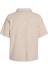 Polo shirt beige a maniche corte, materiale in cotone morbido, colletto standard, vestibilità comoda, texture minimale, senza accenti o motivi prominenti.