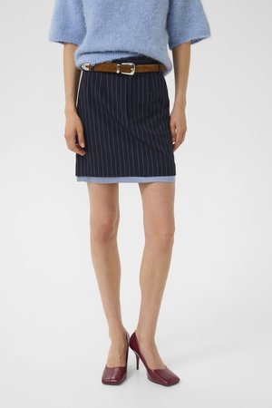Navy pinstriped skirt with a blue underlayer, paired with a brown belt and maroon high heels. Soft blue fuzzy sweater completes the outfit.