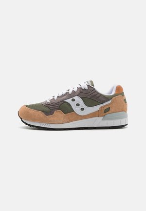Baskets basses en daim marron, mesh vert, logo blanc et lacets blancs sur fond blanc, vues de profil.