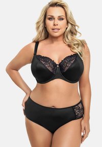 Zwarte beha met kantafwerking, met een gemold ontwerp en een subtiele glans. Bijpassende zwarte high-waisted slip met kantdetails aan de zijkant.