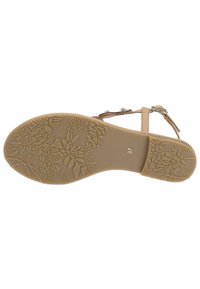 Sole in beige con motivi floreali e fogliari. Texture liscia con una forma sagomata. Taglia contrassegnata come 37.