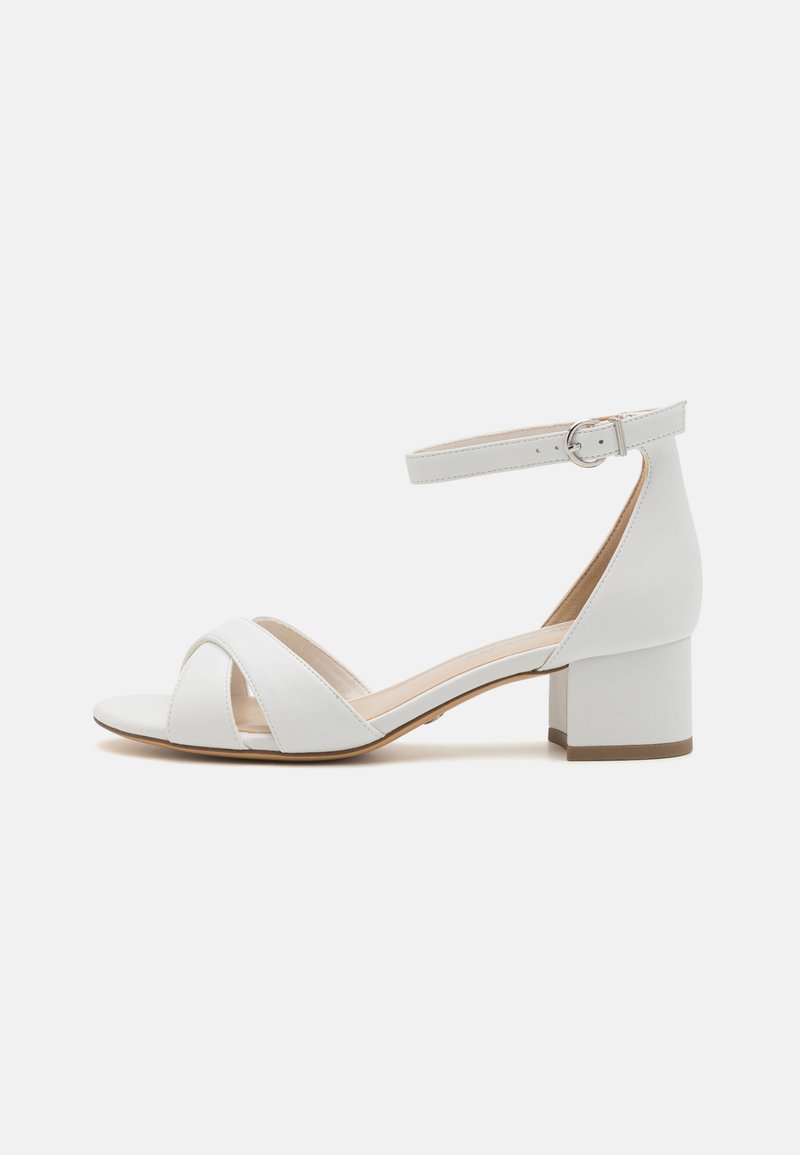 White leather block-heeled sandals with a cross-strap design and ankle strap featuring a silver buckle. Smooth texture with a beige insole.
