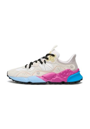 Multicolored sneaker featuring a beige suede upper, black laces, and a textured rubber sole with blue, pink, and orange accents.