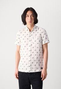Short-sleeve, white button-up shirt featuring a pattern of navy blue stripes and squares. Has a chest pocket and a relaxed fit.
