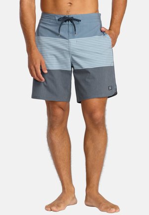Men's swim shorts in blue with horizontal stripes. Features a drawstring waistband and logo patch. Material appears lightweight and smooth.
