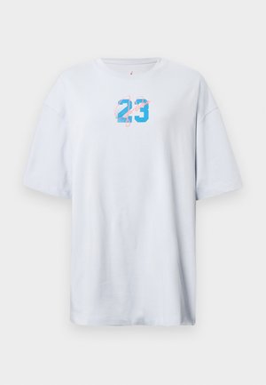 White oversized t-shirt made of cotton, featuring a blue "23" and pink script. Short sleeves and a round neckline. Smooth texture.