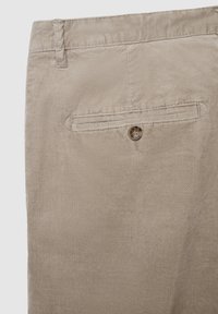 Beige Kordhosen mit einer Gesäßtasche mit Knopfverschluss und dezenter Ripptextur. Weicher Stoff mit einer glatten Oberfläche.