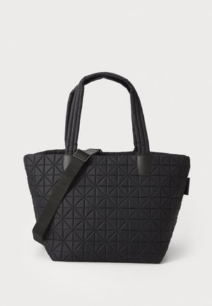 Black quilted tote bag with a geometric pattern, featuring two fabric handles and a detachable shoulder strap. Smooth texture and structured shape.