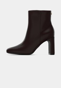 Dark brown leather ankle boot with block heel, rounded toe, and smooth finish, shown from the side on a white background.