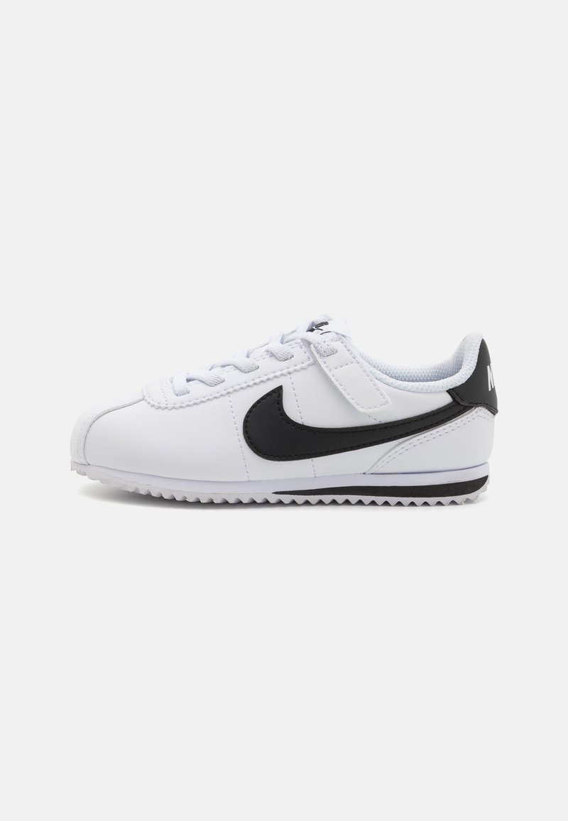 Bijele kožne tenisice s crnim swoosh logom, teksturiranom gumiranom potplatom i dizajnom na vezanje. Imaju zaobljeni vrh i podstavljeni ovratnik.