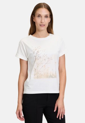 White short-sleeve T-shirt with a floral graphic print featuring soft colors and the word "breathe" in a cursive font at the center.