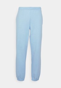 Ljust blå sweatpants gjorda av mjukt tyg, med elastisk midja och åtsittande muddar. Slät yta och enkelt, utan utsmyckning design.