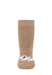 Beige Kniestrümpfe mit geripptem Muster. Nahe dem Saum befindet sich ein Design eines weißen Hundes in Marineblau und Weiß. Weicher, dehnbarer Stoff.