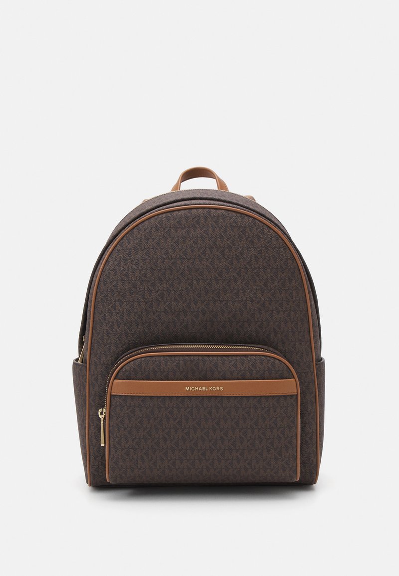 Brown fabric backpack with an interlocking logo pattern, brown leather accents, gold zipper hardware, and a front zipped pocket.