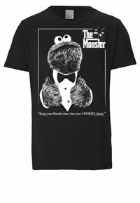 Black t-shirt featuring a graphic of a character in a tuxedo with fluffy texture, large eyes, and the quote "Keep your friends close..."