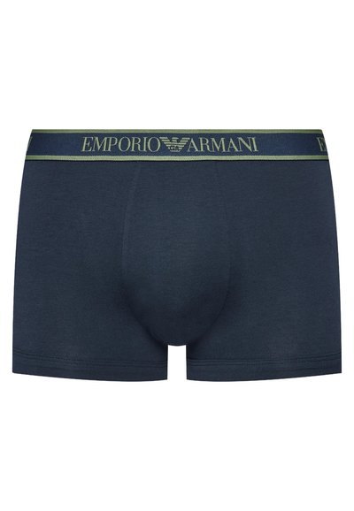 Dark navy cotton trunk briefs featuring a contrasting green Emporio Armani logo waistband and a fitted design with a soft texture.