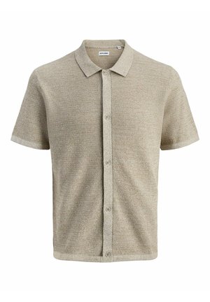 Polo beige à manches courtes en tricot avec patte de boutonnage et tissu texturé.