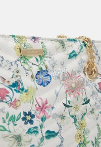 Hvid quilted håndtaske med flerfarvet blomstermønster, guld kædetraspe og guld mærkeplade med teksten "ALDO."
