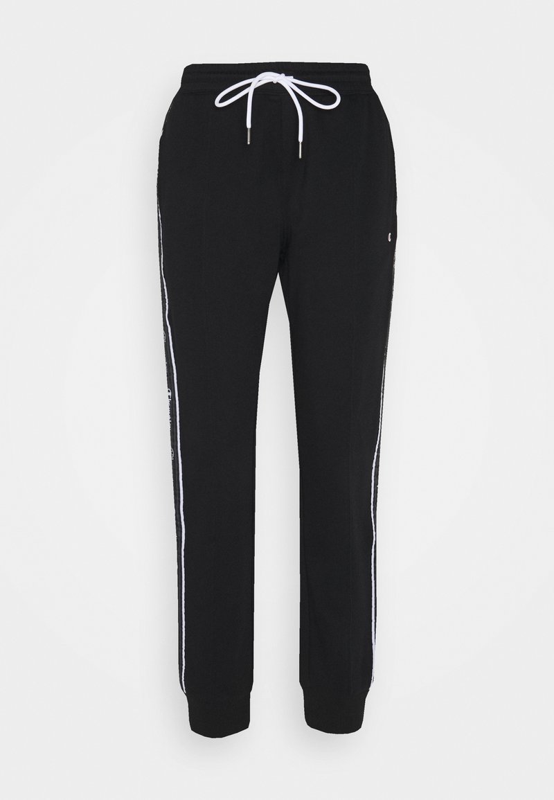Černé tepláky s č drawstring pasem, bílými bočními pruhy a slim fit střihem. Vyrobené z měkkého materiálu s žebrovanými manžetami na kotnících.