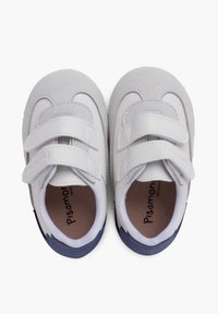 Scarpe in pelle bianca con dettagli in suede grigio, due cinturini in velcro e suole in gomma blu. Soletta interna etichettata "Pisamonas." Design a punta rotonda.
