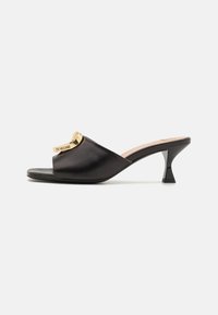 Black leather high-heel mules featuring an open toe, curved design, and a gold-tone hardware accent with "Love Moschino" branding.