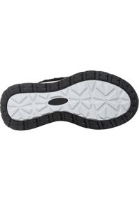 Skoled med en tekstureret sort gummiydre og en hvid mellemsål, med et hexagonalt slidbane mønster for greb og holdbarhed.