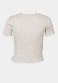 Haut en tricot à manches courtes de couleur beige clair avec une texture subtilement côtelée et une petite bordure en dentelle festonnée au niveau du décolleté.