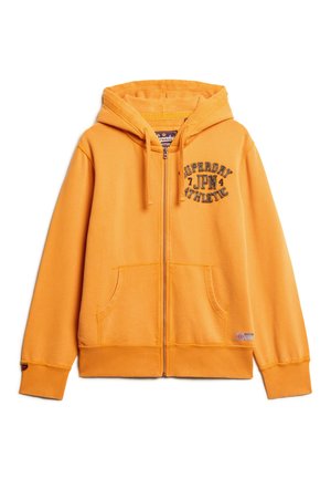Orange zip-up hoodie med et frontlogo, to sidelommer og snoretræk i hætten. Lavet af blødt stof med ribbede manchetter og nederkant.