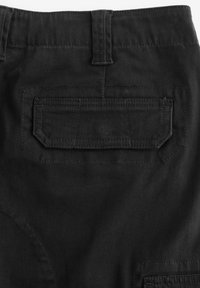 Schwarze Baumwollhose mit einer hinteren Tasche mit kantigem Design, sichtbaren Nähten und einer glatten Textur. Gürtelschlaufen am Bund.
