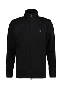 Schwarze Zip-Up-Sweatshirt mit hohem Kragen, aus weichem Stoff, mit zwei vorderen Taschen und einem kleinen Logo auf der Brust.