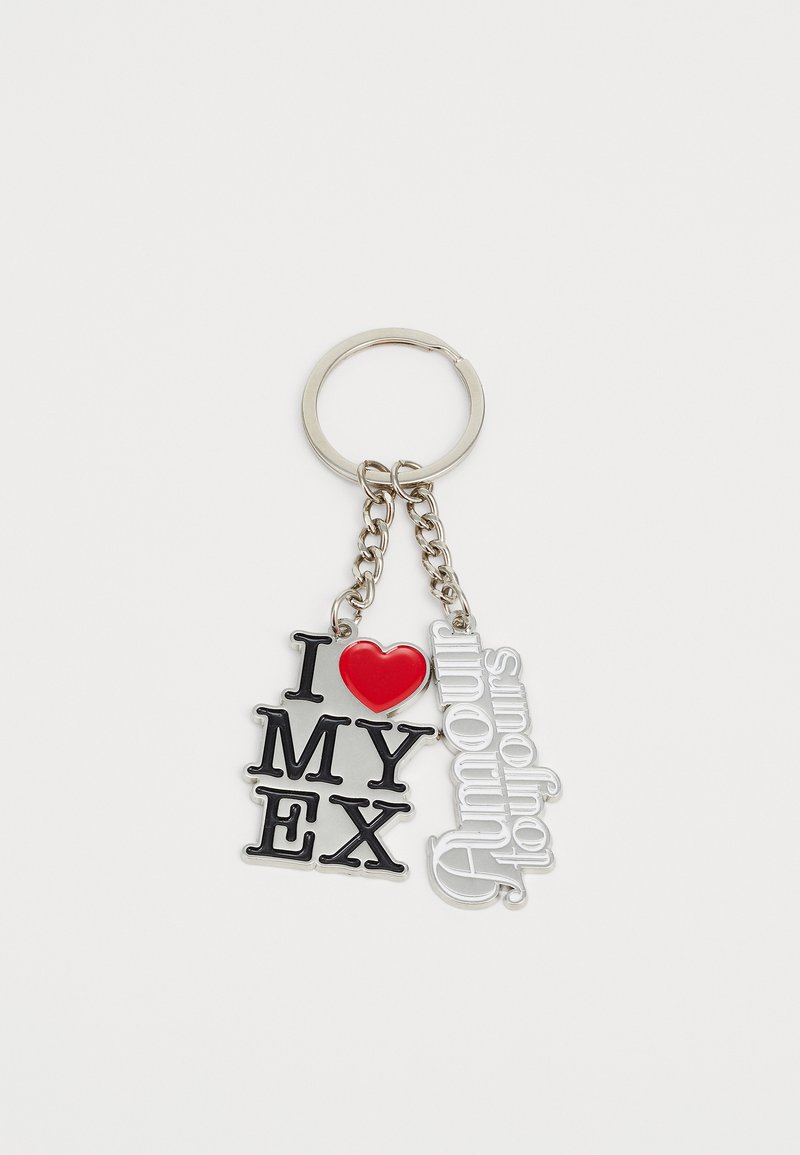 Klíčenka s černým a stříbrným písmem a červeným srdíčkem. Text zní "Mám rád/a své EX" a "Amour toujours," s připojením na stříbrném řetízku.