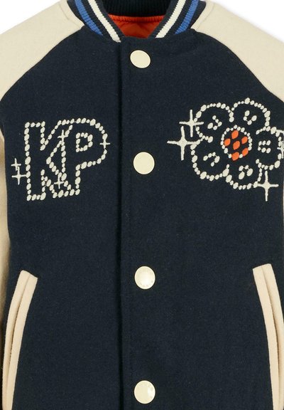 Giacca varsity in misto lana navy con maniche crema, caratterizzata da ricamo "KP" e un design floreale con accenti arancioni, bottoni a pressione dorati.