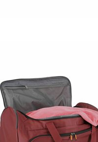 Maroon duffel bag with a zippered top, featuring a pink towel inside. Includes a mesh pocket in the lid for additional storage.