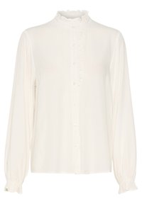 Blouse blanche à manches longues avec col montant à volants, bordure à volants le long de la patte de boutonnage et poignets élastiques à volants.