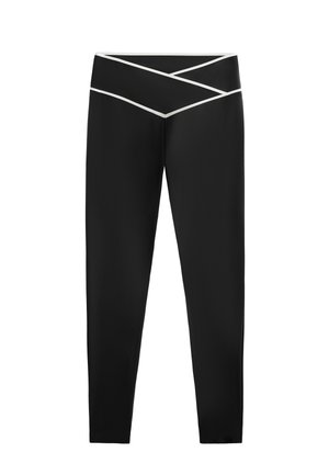 Zwarte leggings met een kruisdessin op de tailleband, met witte accenten. Gemaakt van een gladde, rekbare stof.