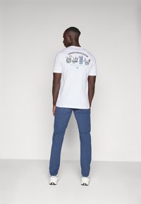 TravisMathew TECH CHINO - Trousers - dress blues