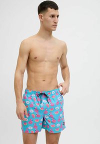 Costume da bagno blu chiaro con motivo di fenicotteri rosa e fette di frutta. Presenta una vita elasticizzata con cordoncino e tasche laterali.