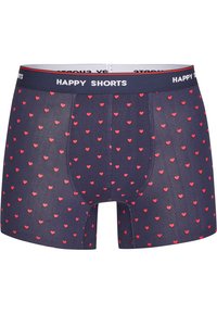 Boxer di colore blu navy realizzati in tessuto elastico con un motivo a cuori rossi ripetuto, dotati di una vita piatta con il marchio "HAPPY SHORTS".