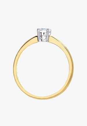 Kollane kuldrõng, millel on siledat tüüpi bänd ja neli hambaid valgest metallist seadist, mille keskel asub selge, ümmargune kivi. Minimalistlik disain.