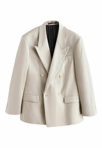 Blazer beige clair croisé avec revers à pointe, quatre boutons devant, deux poches à rabat et doublure intérieure noire, présenté à plat sur fond blanc.