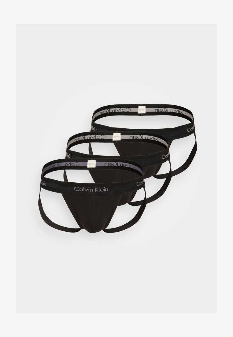 Három fekete tanga alsó, elasztikus Calvin Klein márkázott derékrésszel, sima anyaggal és kontúrozó dizájnnal.