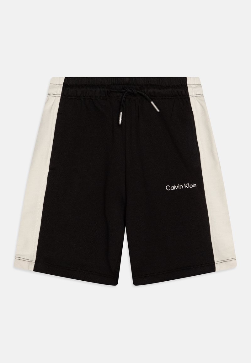 Short noir avec panneaux latéraux blancs, taille élastique avec lien de serrage et logo Calvin Klein sur la jambe avant droite