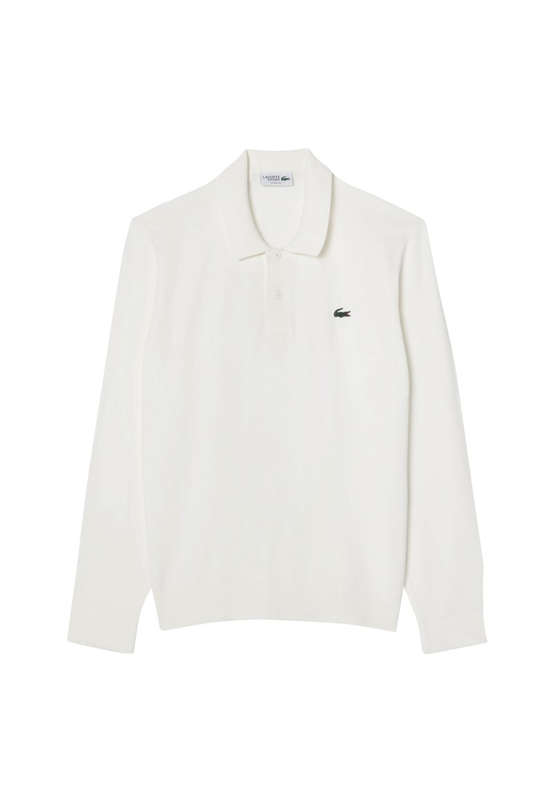 Polo a maniche lunghe bianco con colletto classico, caratterizzato da un piccolo logo verde Lacoste sulla parte sinistra del petto. Tessuto in cotone.