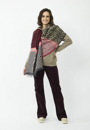 Multi-patterned rectangular scarf featuring a mix of leopard and geometric designs in red, black, and pink. Fringed edges.