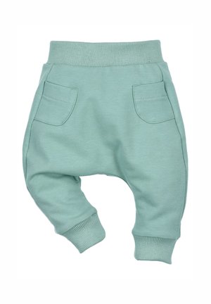 Hellgrüne Jogginghose aus Baumwollmischung. Verfügt über einen gerippten Bund, Bündchen und zwei vordere Taschen mit sichtbaren Nähten.