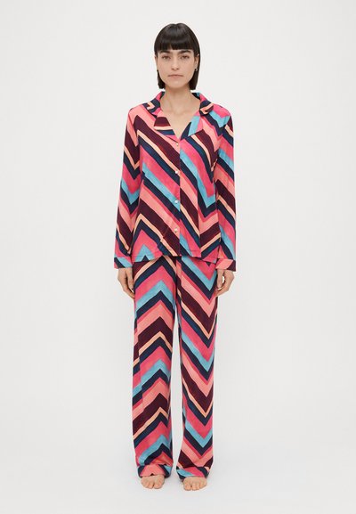 Two-piece pajama set in chevron pattern with pink, blue, and navy colors. Smooth fabric, long sleeves, and button-front shirt. Wide-leg pants.