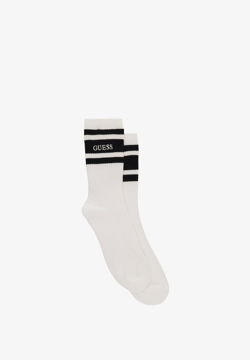 White cotton socks featuring two black stripes at the top and "GUESS" logo in black. Smooth texture, standard crew length design.